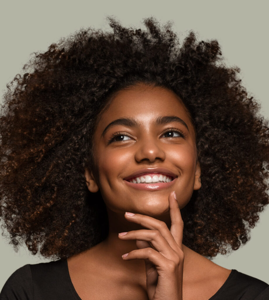 Beautiful african woman black t-shirt portrait afro haircut touching her face Color background green