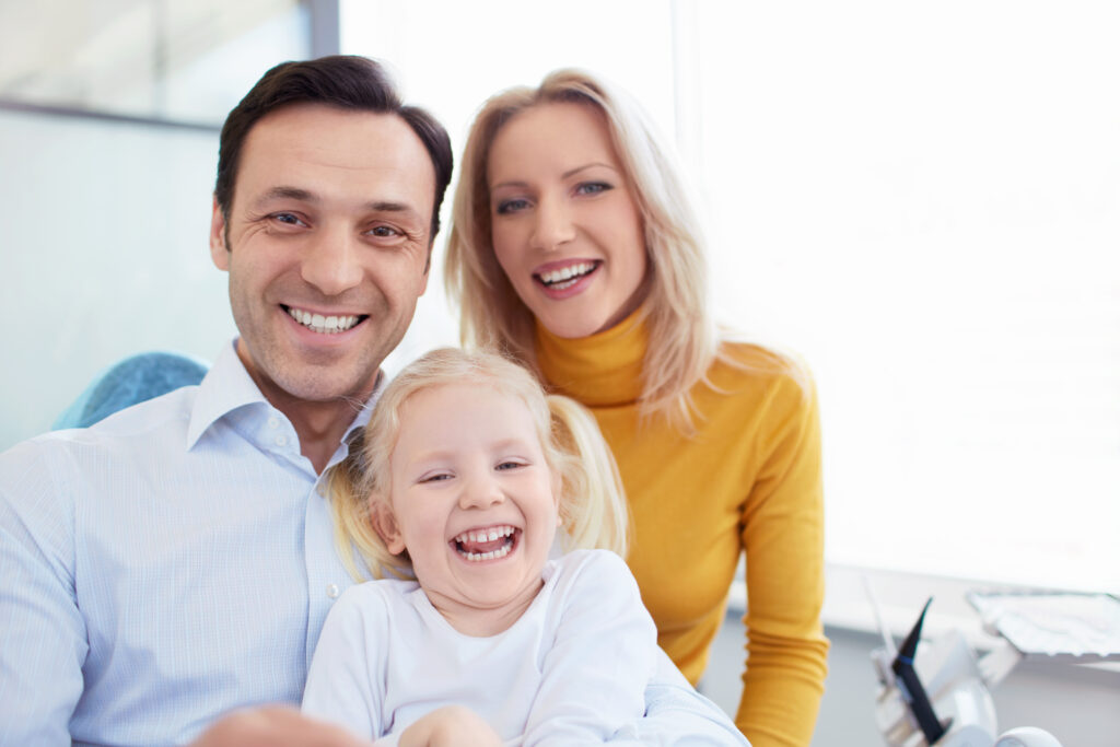 Smiling family in a dental clinic