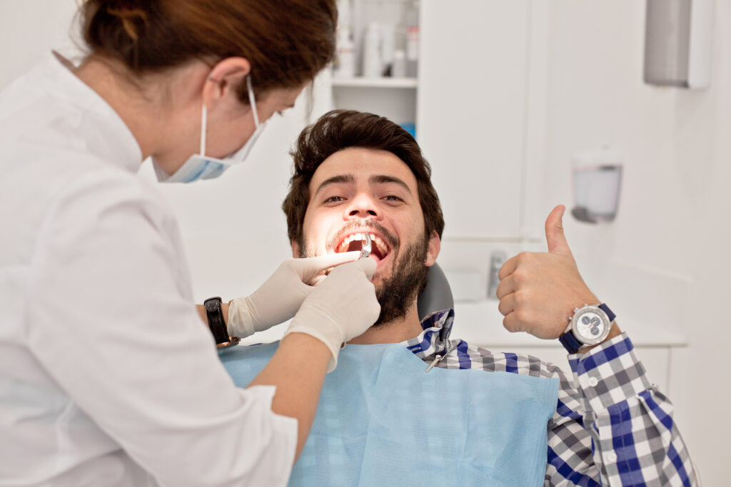 young happy man and woman in a dental examination at dentist