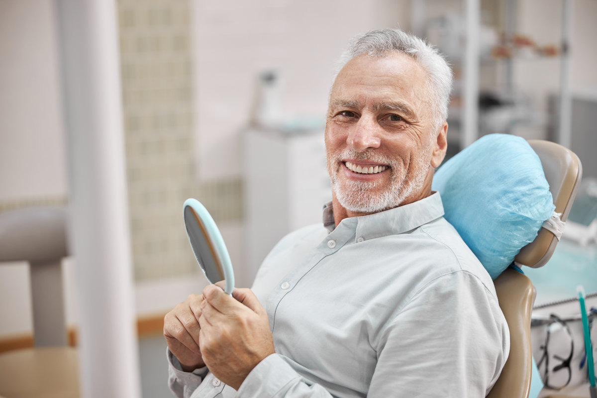 Patient smiling after full mouth dental implants at North Creek Dental Care in Tinley Park