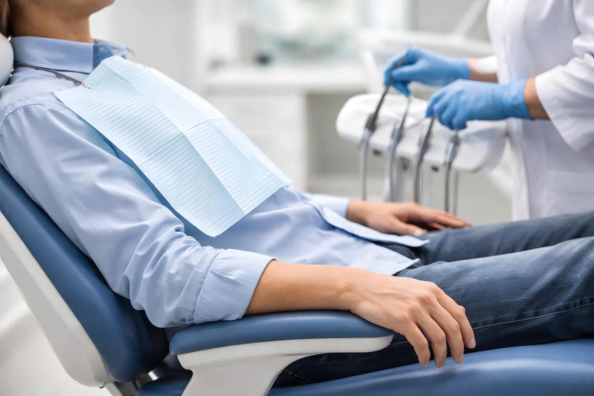 Patient in Dental Chair During Dental Visit, Face Not Visible